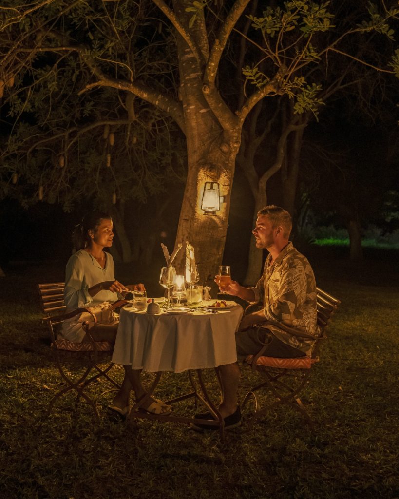 couple men and woman on a romantic dinner on a luxury safary,South Africa, luxury safari lodge